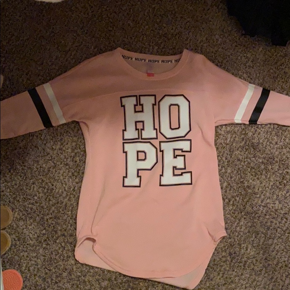 A pink shirt that says hope on it.